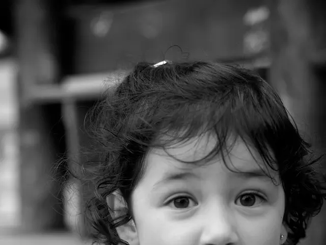 In this image there is a girl towards the bottom of the image, there is a wooden object towards the...