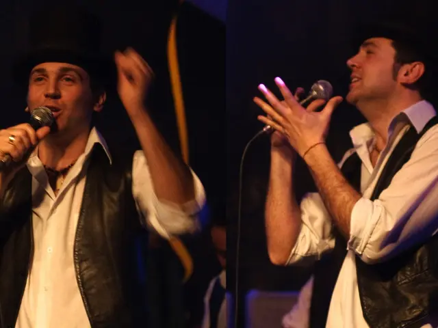 This picture describes about group of people, in front of the image two persons are singing with...