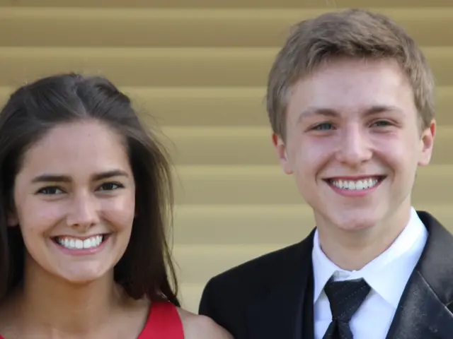 This is the man and woman smiling. In the background, that looks like a window shutter.