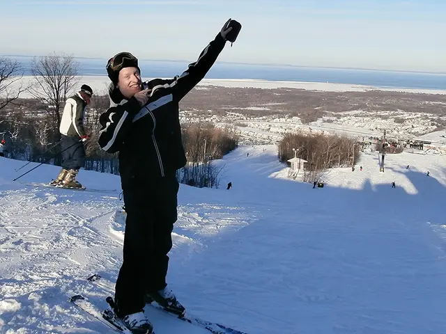 In the center of the image there is a person with ski board on the snow. In the background we can...