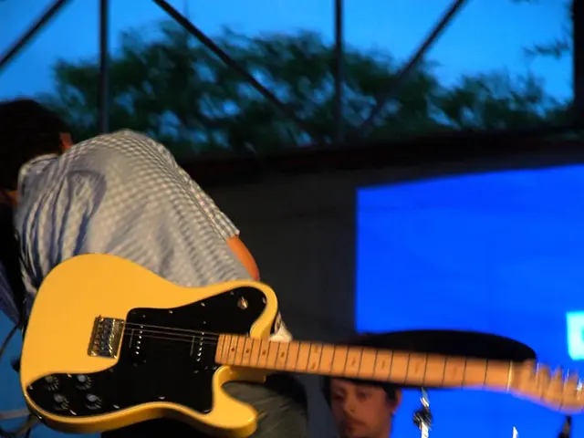 Two men are playing music on a stage.