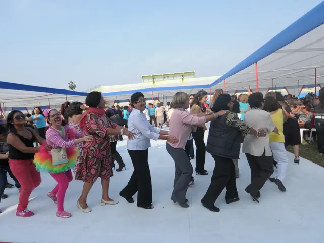 In this picture I can see some people are under the tents and few people are playing on the white...