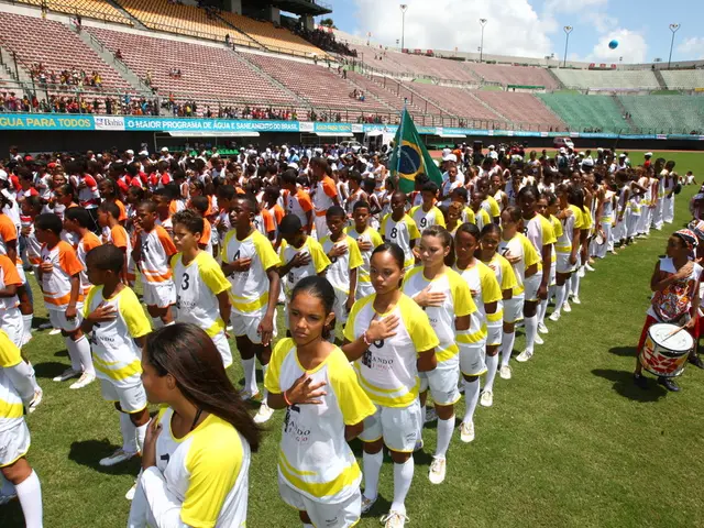 In this picture we can see a group of girls and boys standing in the stadium. Behind we can see...