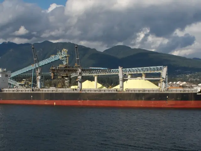 In this picture I can see there is a ship sailing on the water. There are iron frames in the...