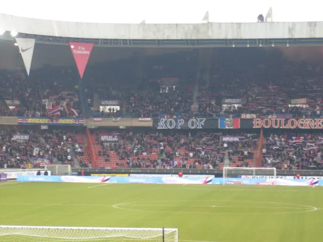 This is clicked inside a stadium, the floor is of grass with goal post on either side of it and in...