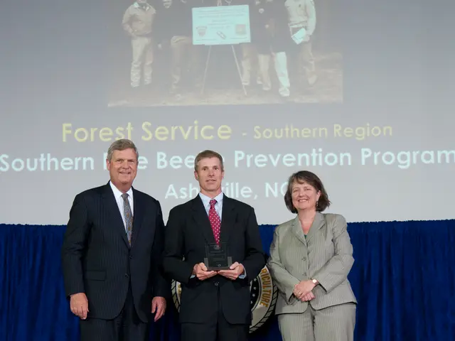 In this picture there are two men wearing black color coat, smiling and giving a pose into the...