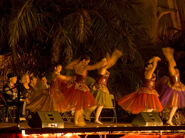 This image is taken in the dark, we can see these people are dancing on the stage and these people...