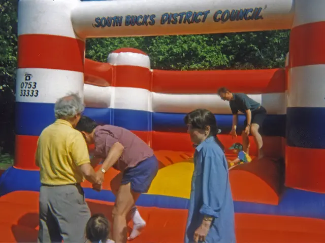 This image is taken outdoors. In the background there are many trees. In the middle of the image...