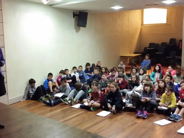 In this picture I can observe some children sitting on the floor. There are some books in front of...