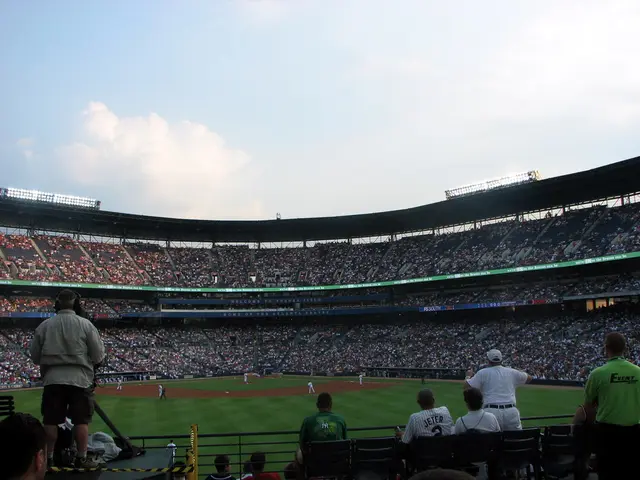 In this picture there is a view of the stadium. In the front there is a grass ground and some...