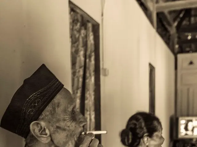 There is one man sitting and smoking a cigarette as we can see on the left side of this image....