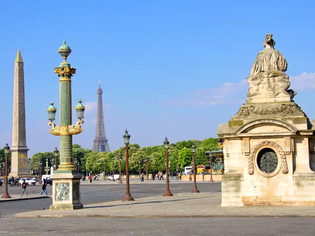 In this image I can see a sculpture. There is a tower and there is an obelisk. There are trees,...