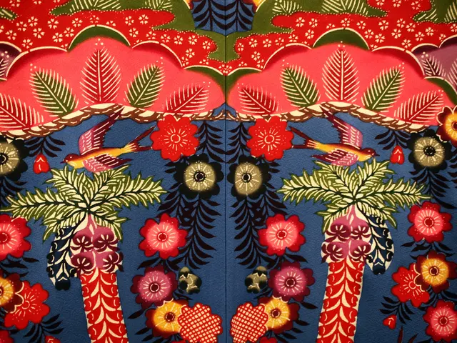 The picture consists of a blanket, on the blanket there are flowers, leaves and tree designs.