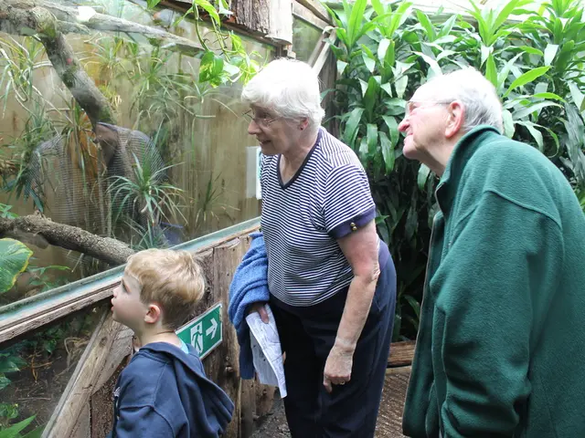 In this image there is a man and a woman and a kid, in front of them there is a glass in that glass...
