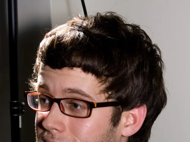 The man is highlighted in this picture. He wore spectacles and black jacket. Black rod.