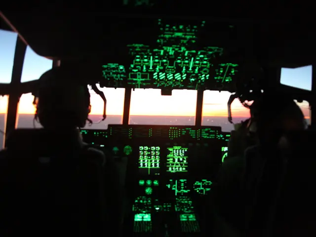 This is an inside view of an airplane, where there are two persons are sitting on the seats and...