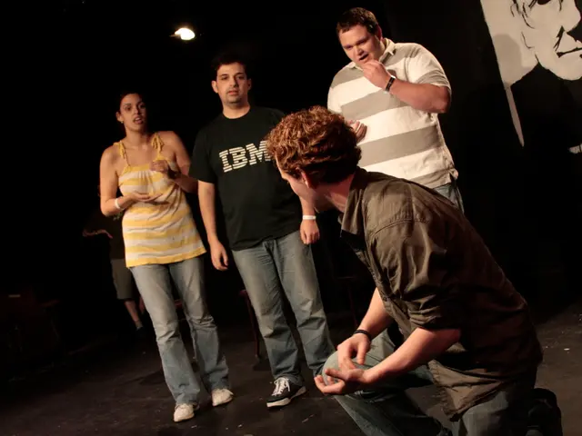 In this image there are four persons performing an act on stage, in the top right there is a...