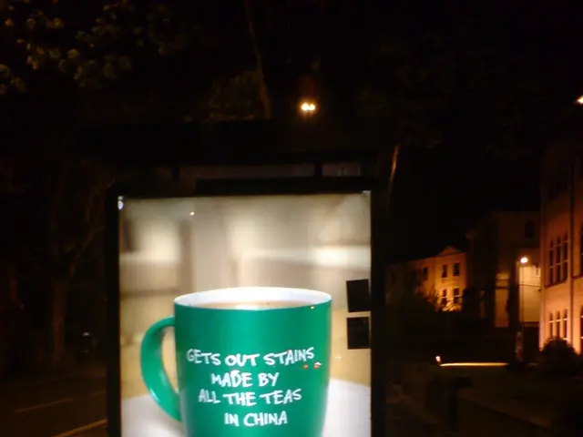 Here in this picture we can see a hoarding present and in that we can see picture of a mug present...