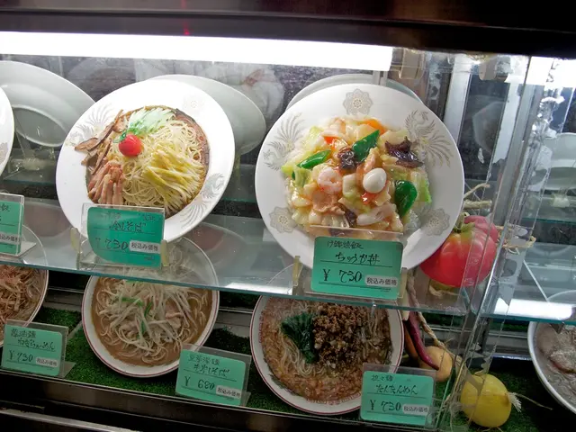 In this picture we can see plates with food items on it and price boards in racks.