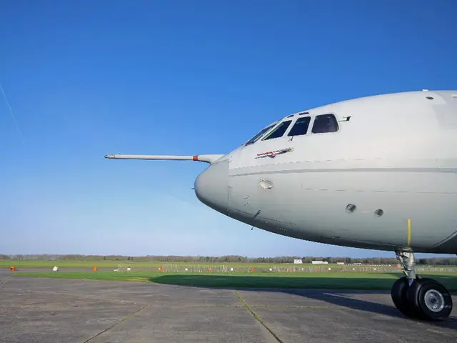 In this image we can see an aeroplane on the land. In the background of the image, we can see...