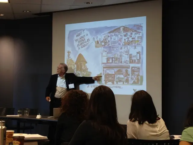 This picture is clicked in a conference hall. In the middle of the picture, we see man in white...