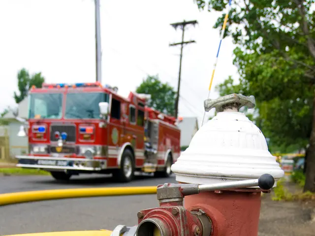 In this image we can see a fire hydrant and yellow color pipe. Background of the image bus,...