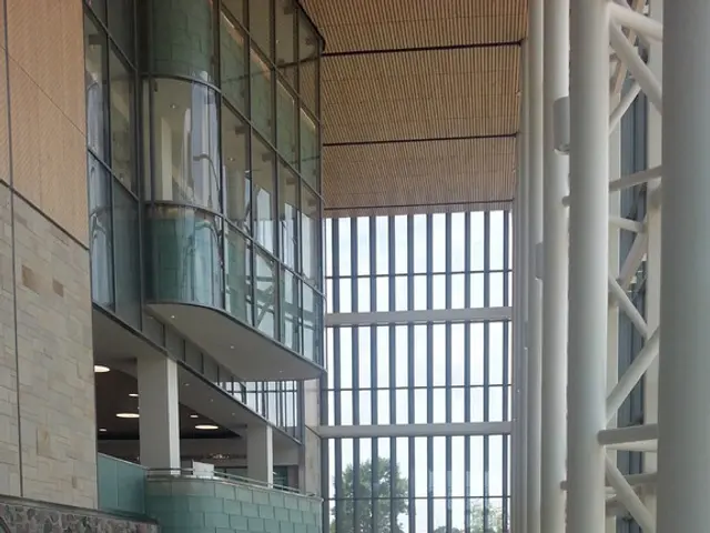 This is an inside view. On the right side there are few poles. On the left side there is a wall...