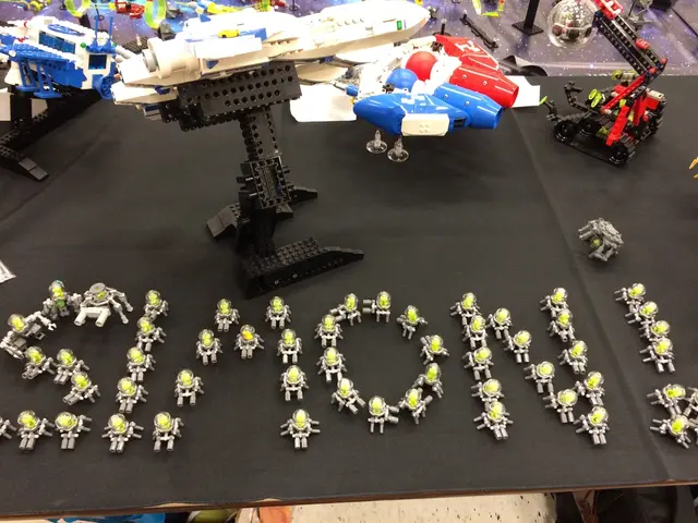 In the image there are many toys,transformers,lego toys on a black mat.