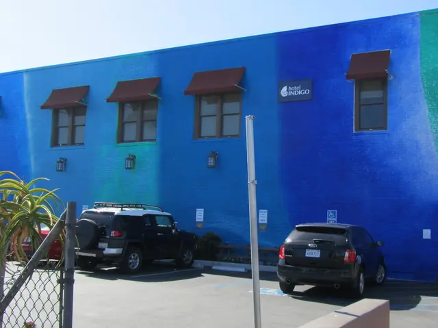 As we can see in the image there are houses, windows, cars, plant, fence, banner and at the top...