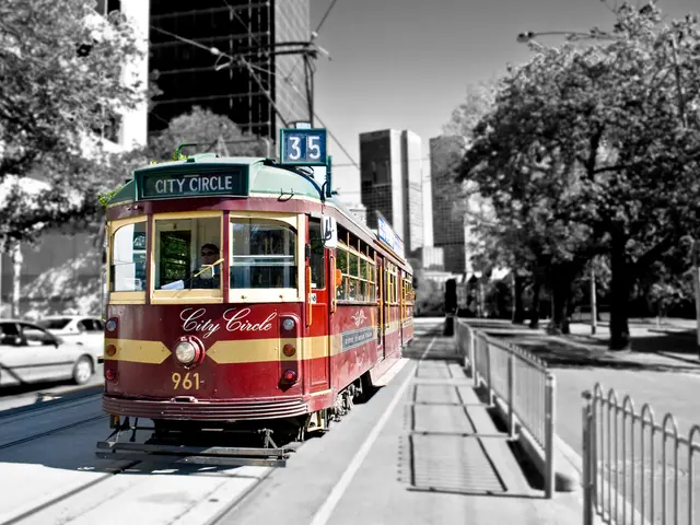 In this image in the center there is a train which is red in colour and the person inside it with...