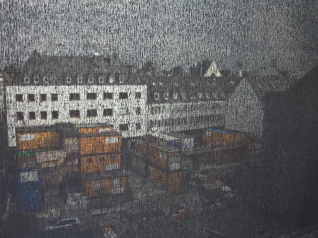 In this picture we can see buildings, roads and cars.