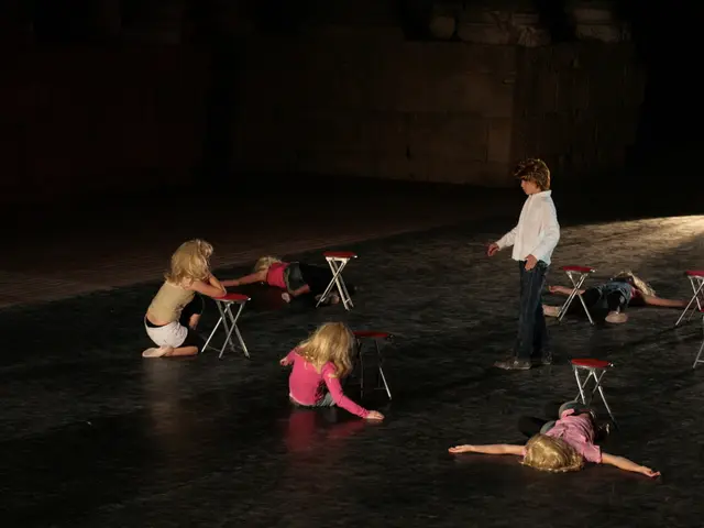In the picture I can see three kids lying on the road and two are sitting on the floor and the...