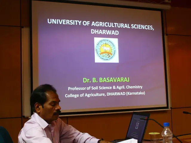 This image is clicked in auditorium where it has a screen and a person is sitting on the left side...