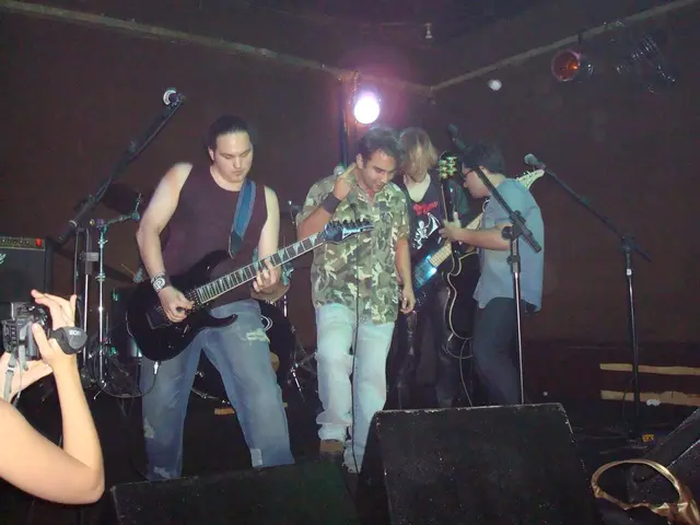 In this image we can see these people are holding guitar in their hands and playing. This person is...