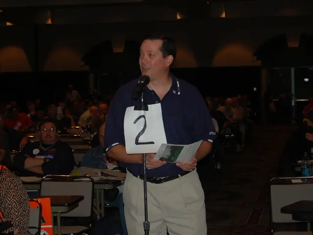 This picture is of inside the stadium. On the right there group of persons sitting on the chairs...