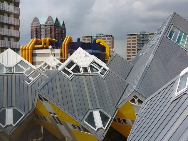 In this image there are buildings and the sky is cloudy.