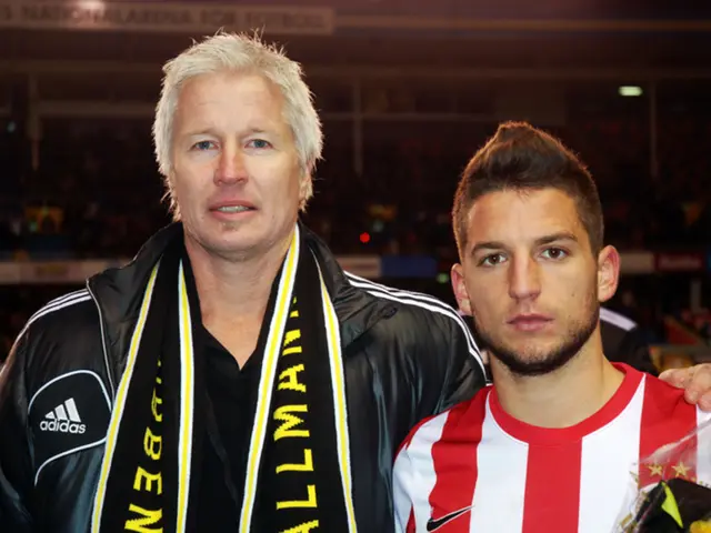 In this image I can see a man is there, he is wearing a black color coat, t-shirt. On the right...