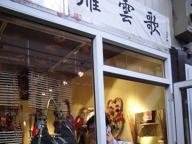 In this image there is a person with mobile phone is standing inside the store on which we can see...