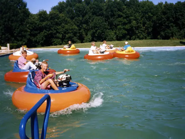 In this image it seems like a swimming pool in which there are tubes on which there are people. In...