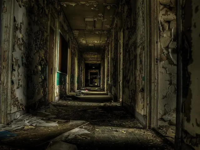 In this picture I see a old building and I see papers on the floor and a board on the left side...