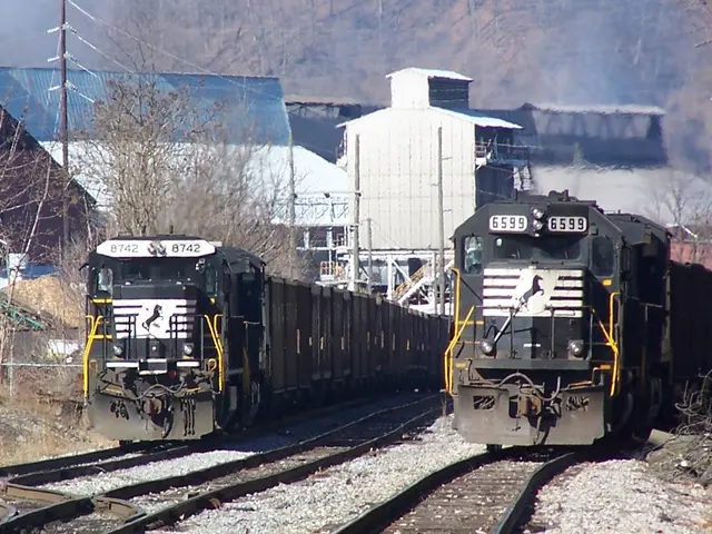 In this image there are two trains on the track, in between the two trains there is an another...