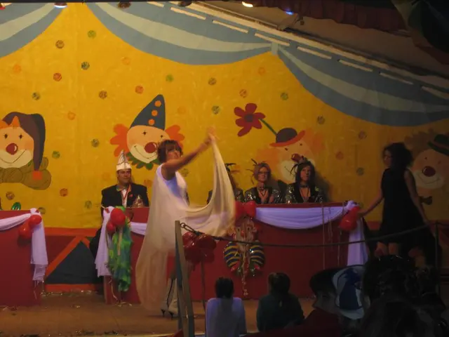 Here I can see few people wearing costumes and doing some actions on the stage. In the background,...