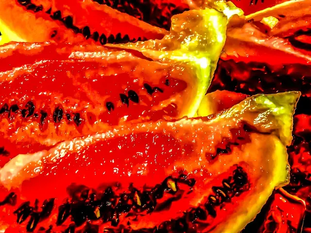 In the image we can see this is a food item, red, black, yellow and orange in color.