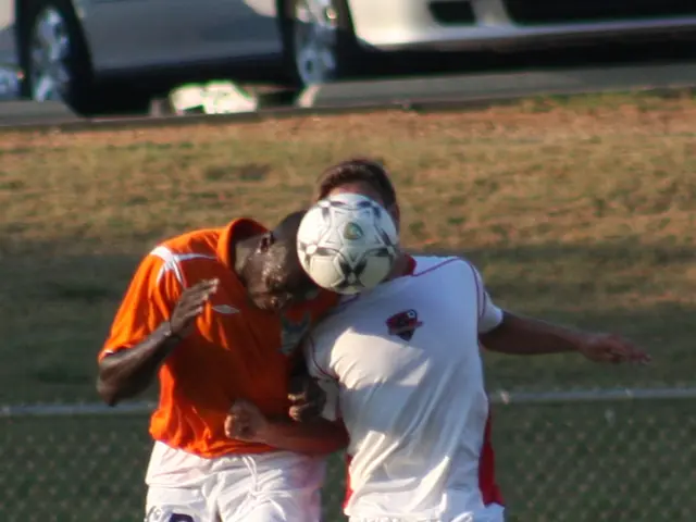 The photo is taken inside a ground. There are two players in the middle of the ground. The player...