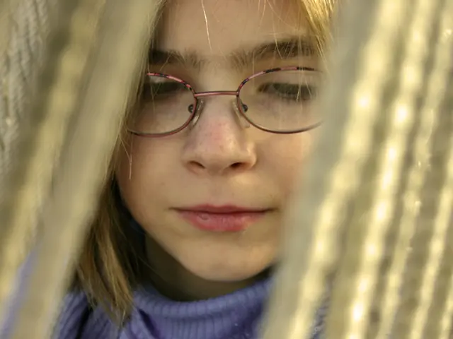 This picture shows a girl with spectacles on her face and we see ropes