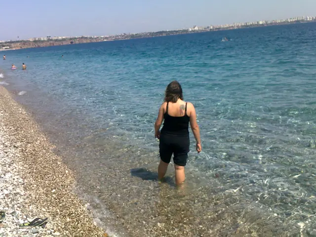 In this image in the center there is one woman who is standing, and on the right side there is a...