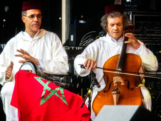 Here in this picture we can see two men sitting over a place and both of them are playing different...