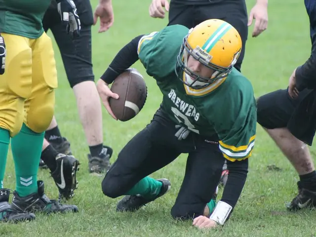 This photo is clicked on ground where many people are playing American football. The man in green...
