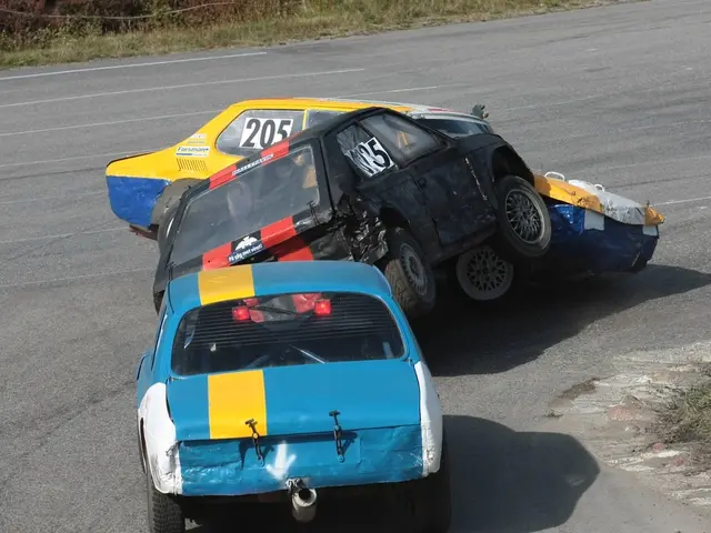 In this image there are three cars on the road which are crashing one another. In the background...