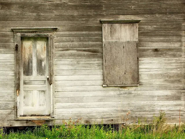 In this picture there is grassland at the bottom side of the image and there is a house in the...